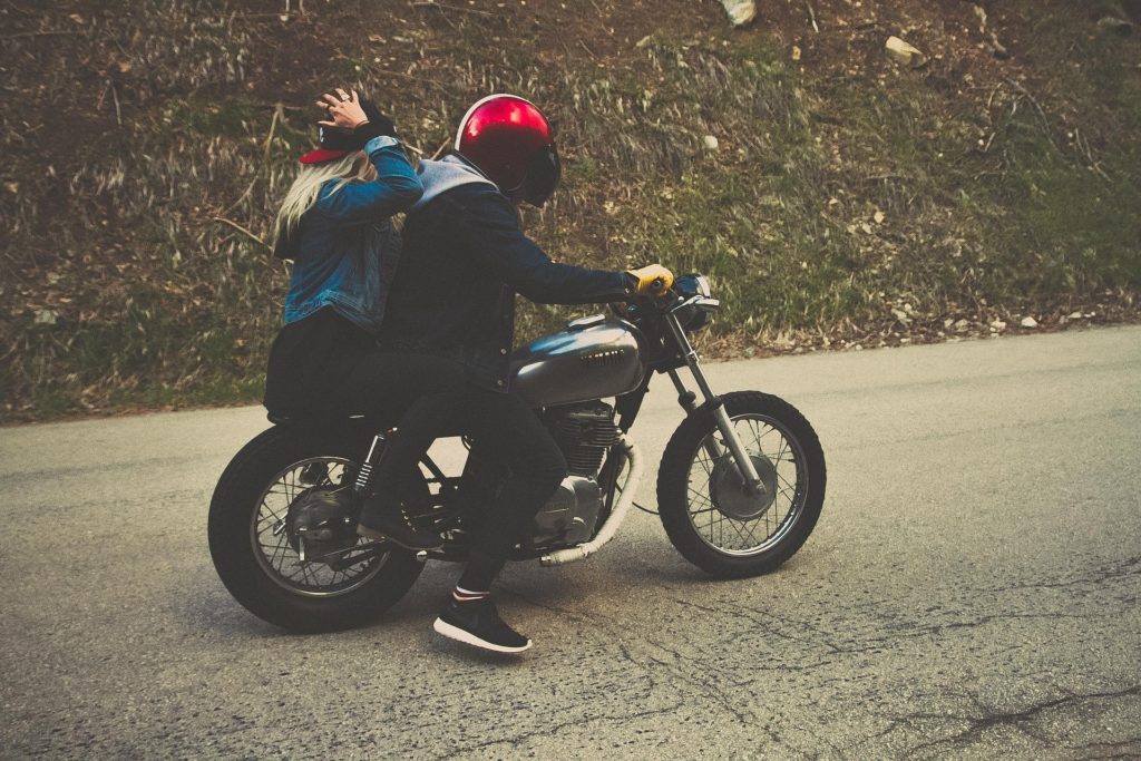 Two people riding a motorcycle
