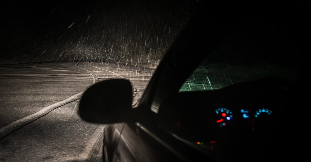 Car Driving in Snow or Rain At Night