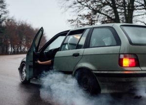 photo of car after accident and car is smoking
