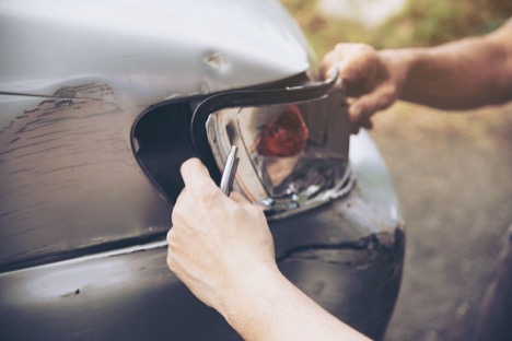 Damaged car being inspected after minor accident