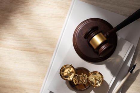 Judge gavel and legal scales on desk